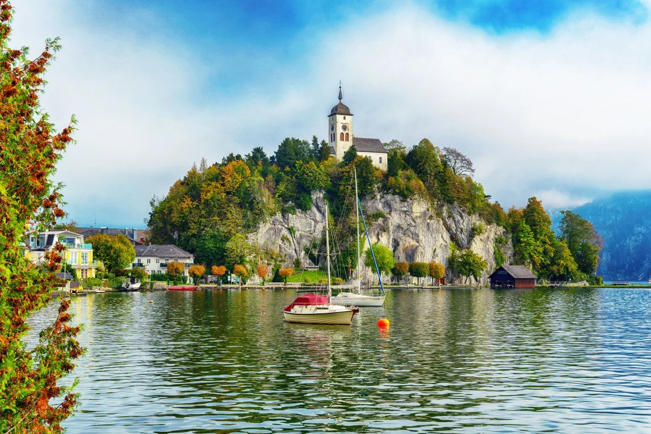 European lakeside village with a church on a hill