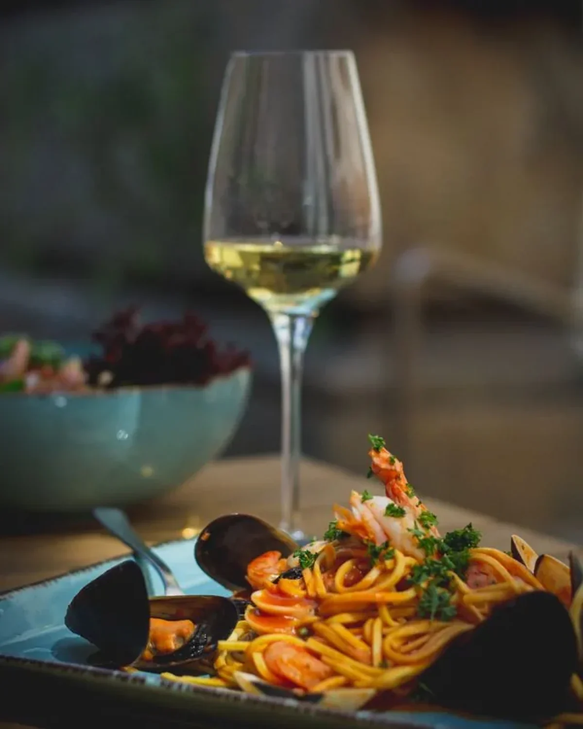 Italian seafood pasta with a glass of wine